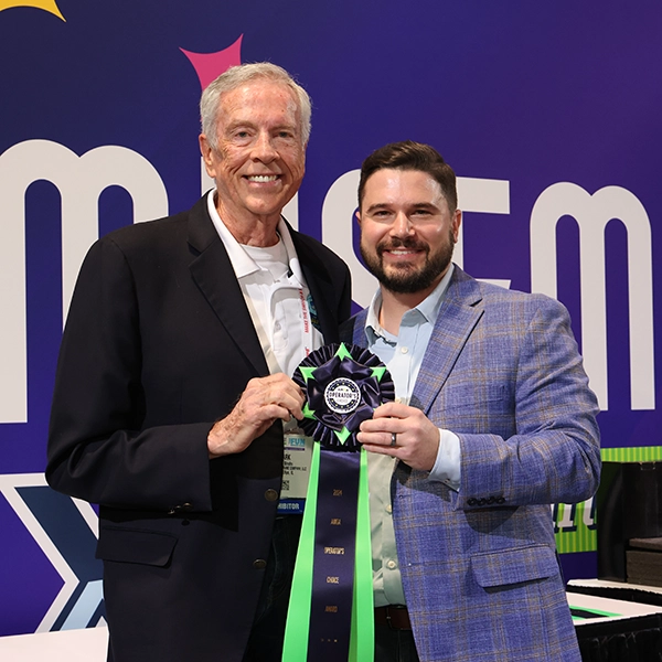 A photo of the Innovator Award ribbon being collected